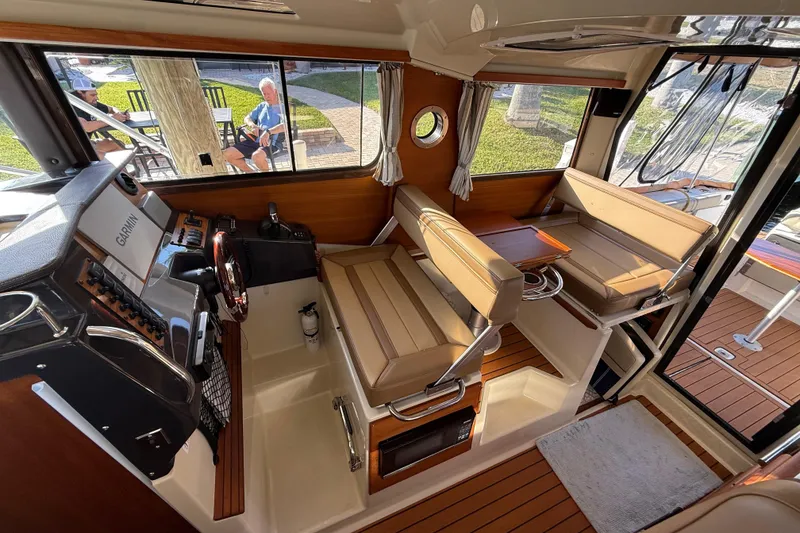 Slide: The Image of Interior of 2022 Ranger Tugs R-27 boat with seating and navigation equipment. - 31