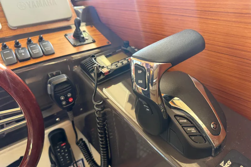 Slide: The Image of Control panel of 2022 Ranger Tugs R-27 with Yamaha throttle and communication devices. - 34