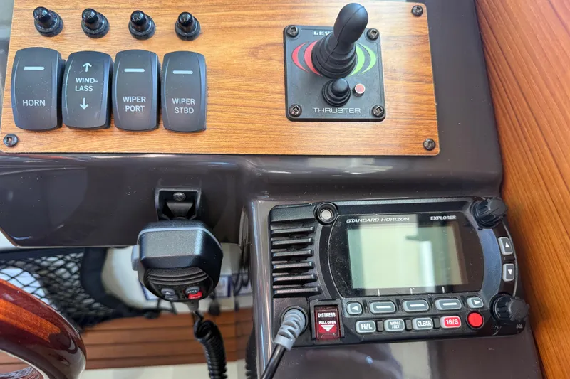 Slide: The Image of Control panel of 2022 Ranger Tugs R-27 with switches and marine radio. - 35