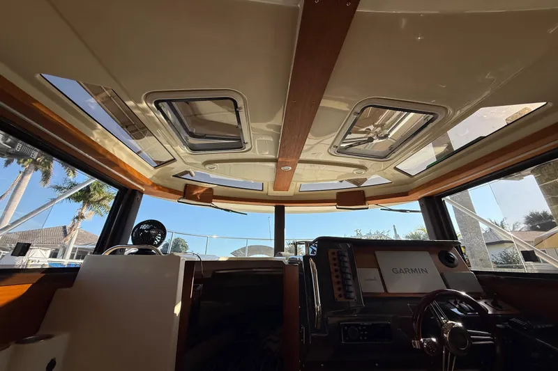 Slide: The Image of Interior view of 2022 Ranger Tugs R-27 boat cockpit with Garmin navigation system. - 38