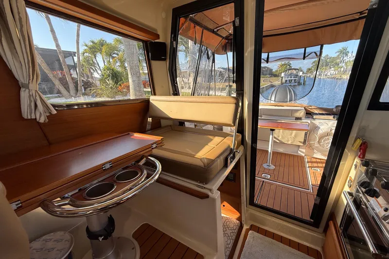 Slide: The Image of Interior of 2022 Ranger Tugs R-27 boat with seating and water view. - 40
