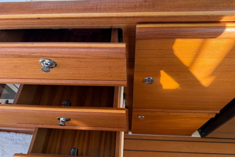 Slide: The Image of Wooden cabinetry with open drawers in a 2022 Ranger Tugs R-27 boat interior. - 47