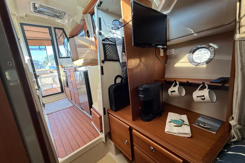 Slide: The Image of Interior of 2022 Ranger Tugs R-27 boat with kitchenette and cozy seating area. - 54