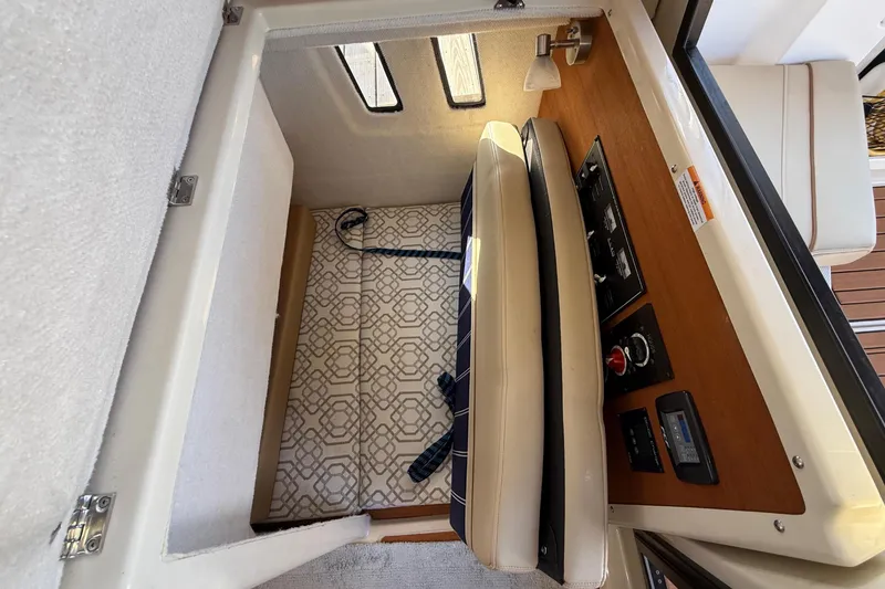 Slide: The Image of Interior view of 2022 Ranger Tugs R-27, showcasing seating and control panel. - 61