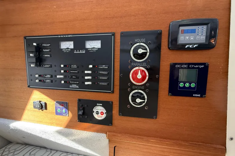 Slide: The Image of Control panel of 2022 Ranger Tugs R-27 boat with various switches and gauges. - 63