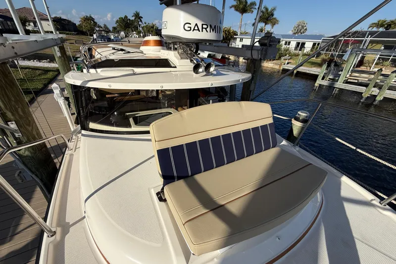 Slide: The Image of 2022 Ranger Tugs R-27 boat with Garmin equipment, docked near a scenic waterfront. - 68
