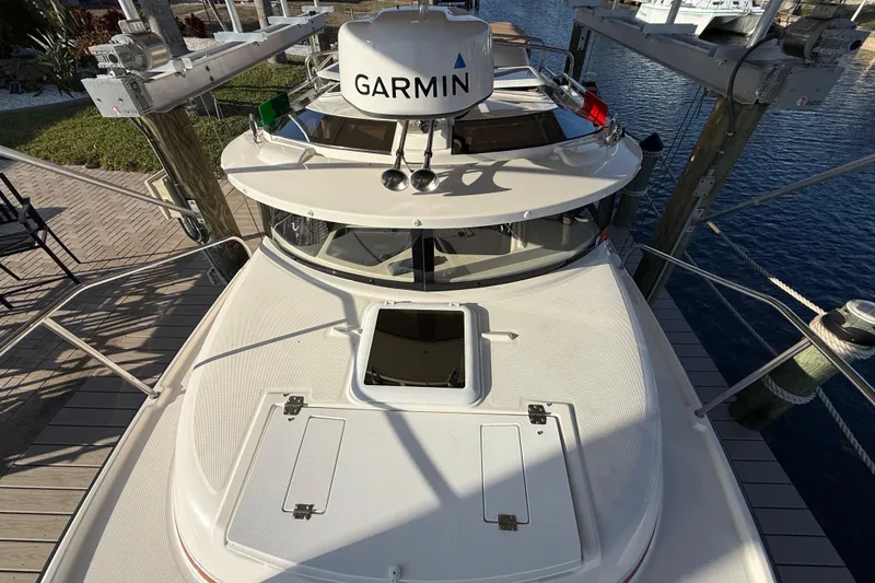 Slide: The Image of 2022 Ranger Tugs R-27 boat docked, featuring Garmin navigation system. - 70