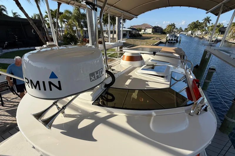 Slide: The Image of 2022 Ranger Tugs R-27 boat docked by a canal, featuring Garmin xHD radar. - 73