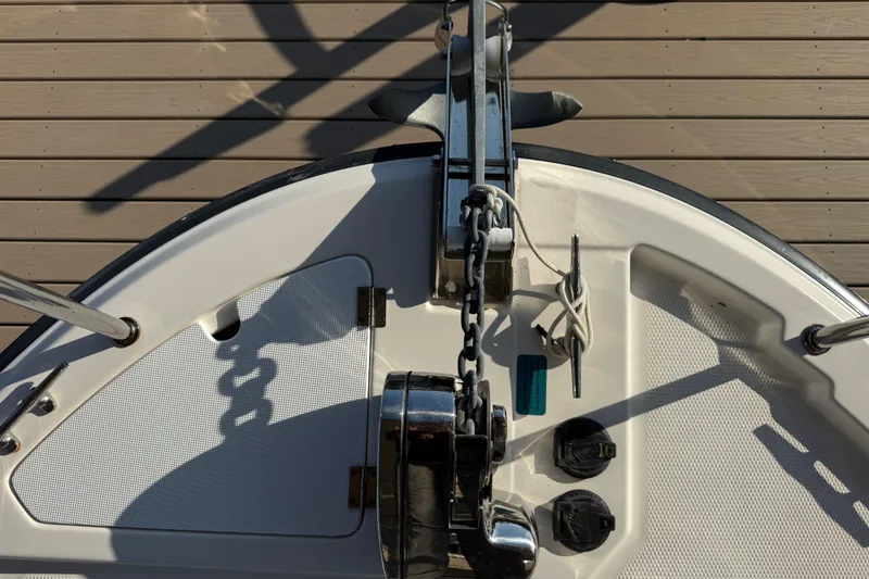Slide: The Image of 2022 Ranger Tugs R-27 boat anchor system on deck, featuring chain and cleat. - 74