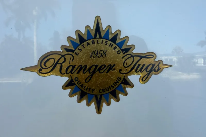 Slide: The Image of Ranger Tugs logo, established 1958, quality cruising emblem on 2022 R-27 model. - 79