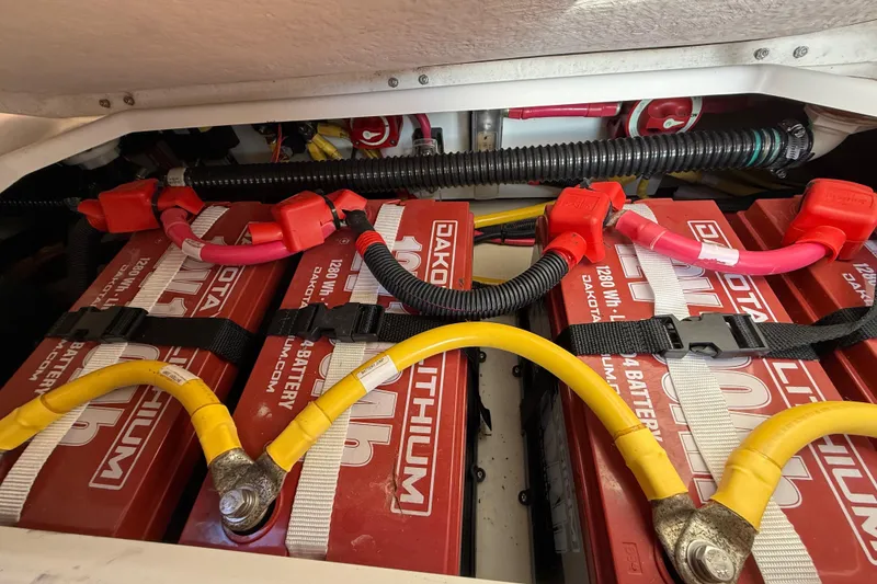 Slide: The Image of 2022 Ranger Tugs R-27 lithium batteries with red and yellow cables connected. - 80