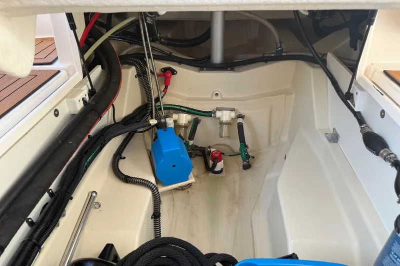 Slide: The Image of 2022 Ranger Tugs R-27 engine compartment with wiring and components. - 82