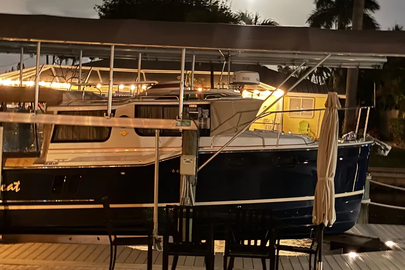 Slide: The Image of 2022 Ranger Tugs R-27 boat docked at night, illuminated by warm lights. - 87