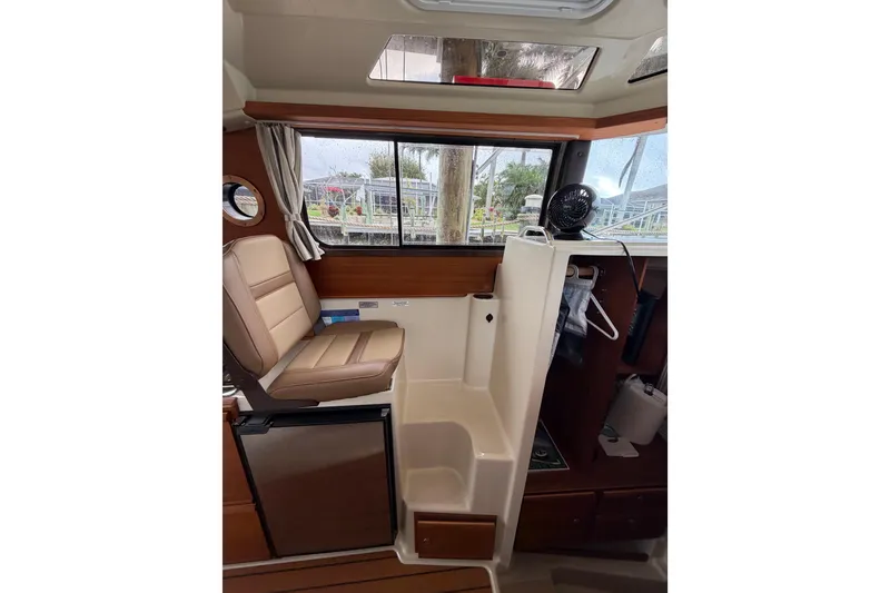 Slide: The Image of Interior of 2022 Ranger Tugs R-27 boat with seating and storage area. - 95