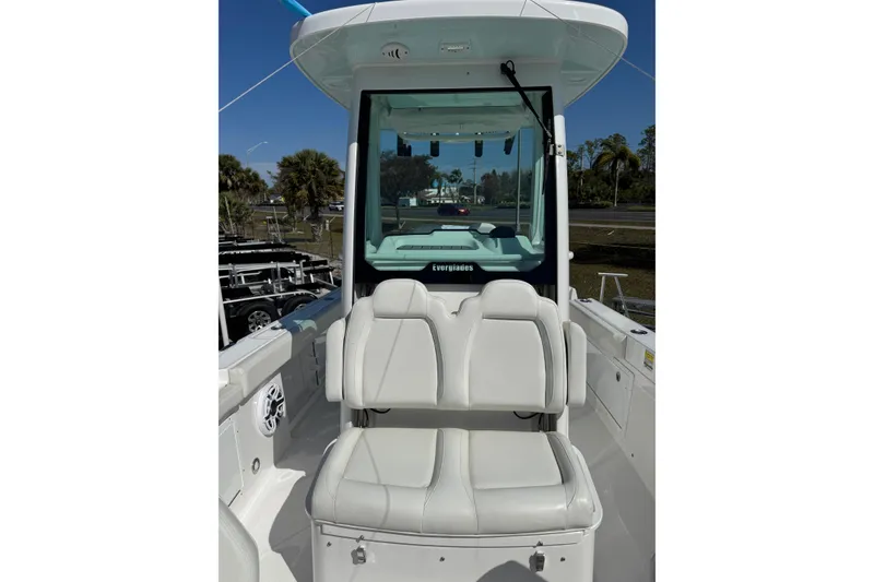 Slide: The Image of 2024 Everglades 235 Center Console boat interior with white seating and console view. - 11
