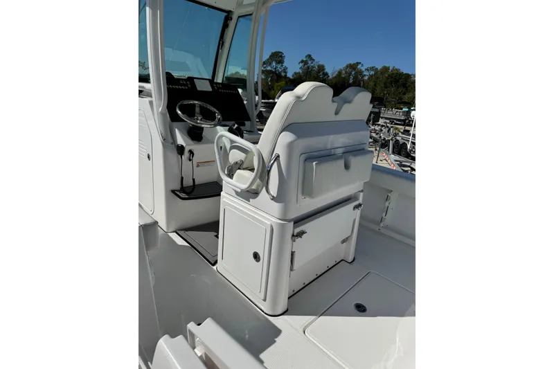 Slide: The Image of 2024 Everglades 235 Center Console boat interior with steering wheel and seating. - 4
