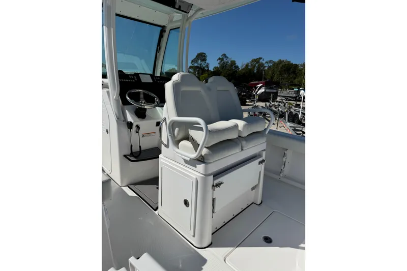 Slide: The Image of 2024 Everglades 235 Center Console boat interior with dual seating and steering wheel. - 5