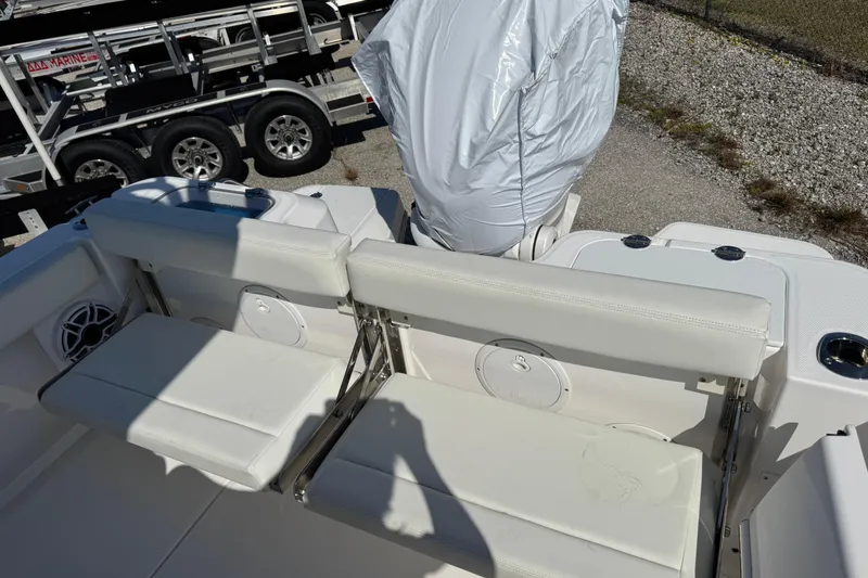 Slide: The Image of 2024 Everglades 235 Center Console boat with white seating and covered engine. - 7