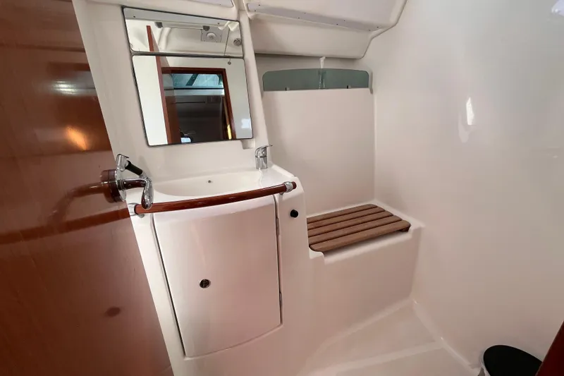 Slide: The Image of Interior of 2008 Beneteau Oceanis 343 yacht bathroom with sink and wooden seat. - 21