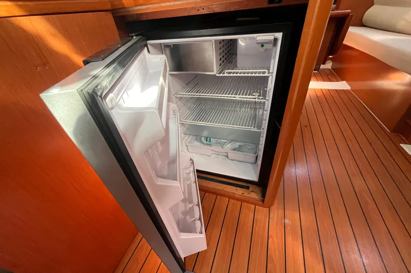 Slide: The Image of Open refrigerator inside 2008 Beneteau Oceanis 343 yacht, showcasing wooden interior flooring. - 26