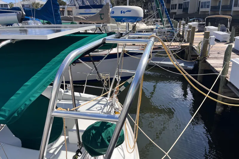 Slide: The Image of Beneteau Oceanis 343 sailboat docked, featuring green canopy and stainless steel frame, 2008 model. - 3