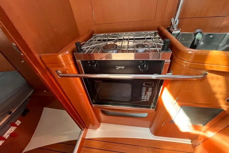 Slide: The Image of Beneteau Oceanis 343 2008 yacht kitchen with stove and microwave. - 30