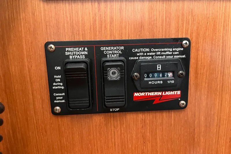 Slide: The Image of Beneteau Oceanis 343 2008 generator control panel with preheat and shutdown bypass switches. - 36