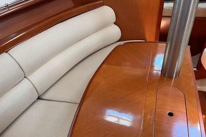 Slide: The Image of Interior of 2008 Beneteau Oceanis 343 yacht with polished wood table and cushioned seating. - 43