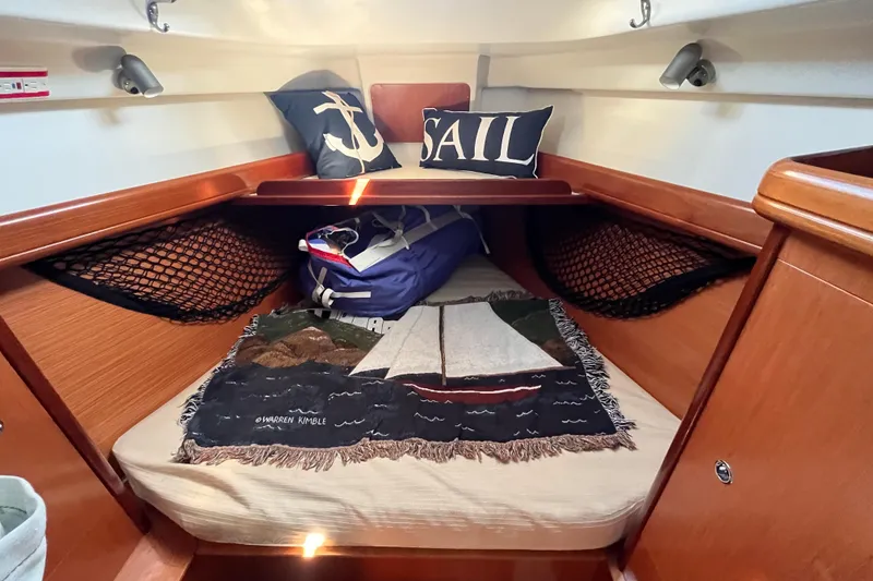 Slide: The Image of Cozy cabin interior of 2008 Beneteau Oceanis 343 sailboat with nautical-themed decor. - 46