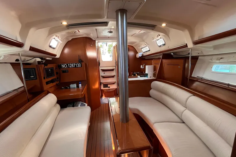 Slide: The Image of Interior of 2008 Beneteau Oceanis 343 sailboat with elegant wood finish and cozy seating. - 48