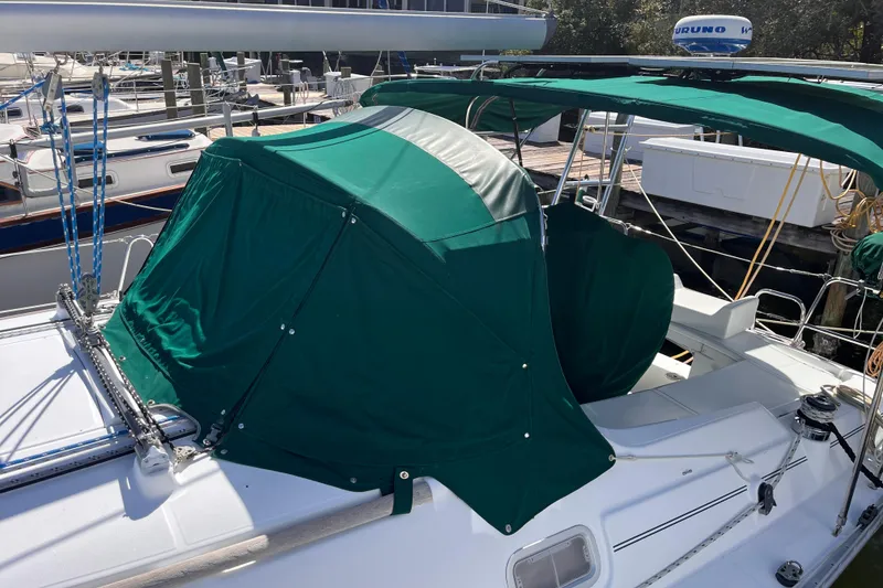 Slide: The Image of 2008 Beneteau Oceanis 343 sailboat with green canopy docked at marina. - 5