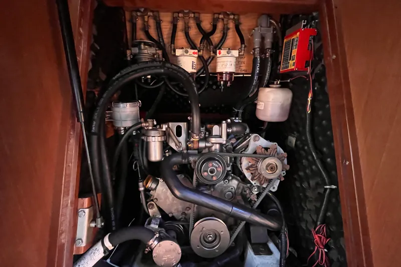 Slide: The Image of Engine compartment of a 2008 Beneteau Oceanis 343 sailboat, showcasing mechanical components. - 54