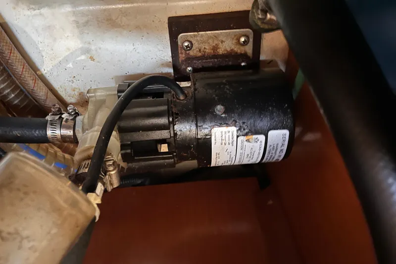 Slide: The Image of Engine component of a 2008 Beneteau Oceanis 343 sailboat, showing hoses and motor. - 62