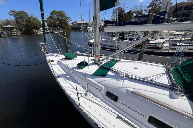 Slide: The Image of 2008 Beneteau Oceanis 343 sailboat docked in a serene marina setting. - 7