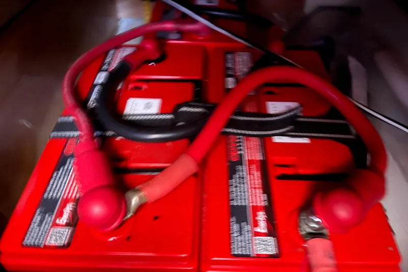 Slide: The Image of Red batteries with cables in a 2008 Beneteau Oceanis 343 sailboat. - 70