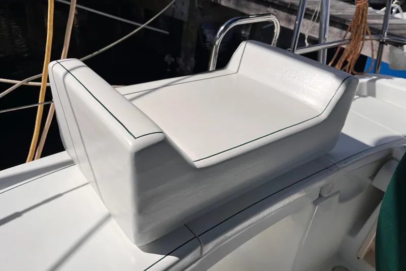 Slide: The Image of White seating on 2008 Beneteau Oceanis 343 sailboat deck, featuring sleek design and stitching. - 9