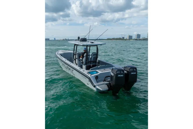 Slide: The Image of 2024 Dynamic D-305V boat with dual engines on open water. - 4