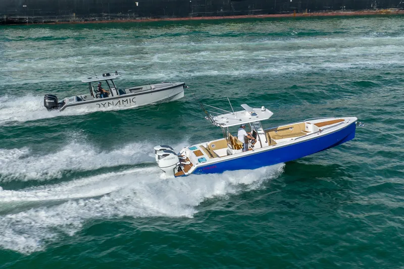 Slide: The Image of Two Dynamic boats, including a 2024 D-305V, speed through ocean waves. - 5