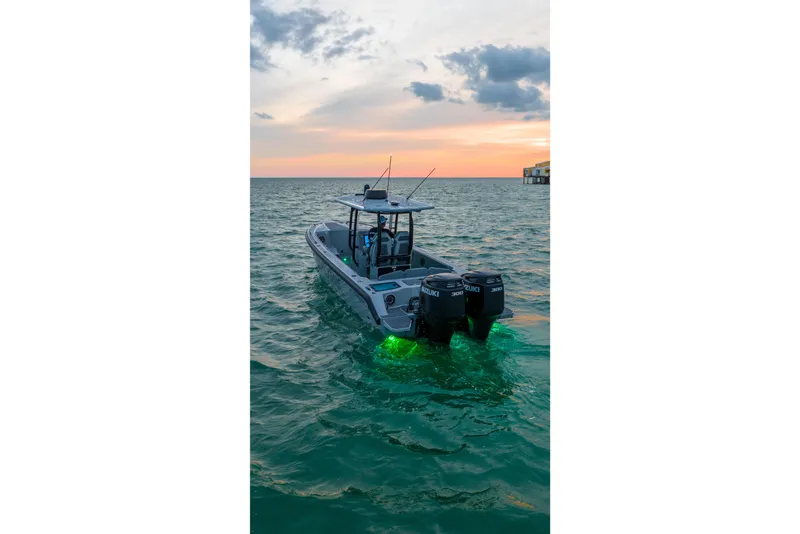 Slide: The Image of Dynamic D-305V boat at sunset with glowing underwater lights, 2023 model. - 8