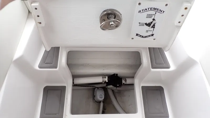Slide: The Image of 2024 Statement 350 Open boat storage compartment with plumbing and secure latch. - 10