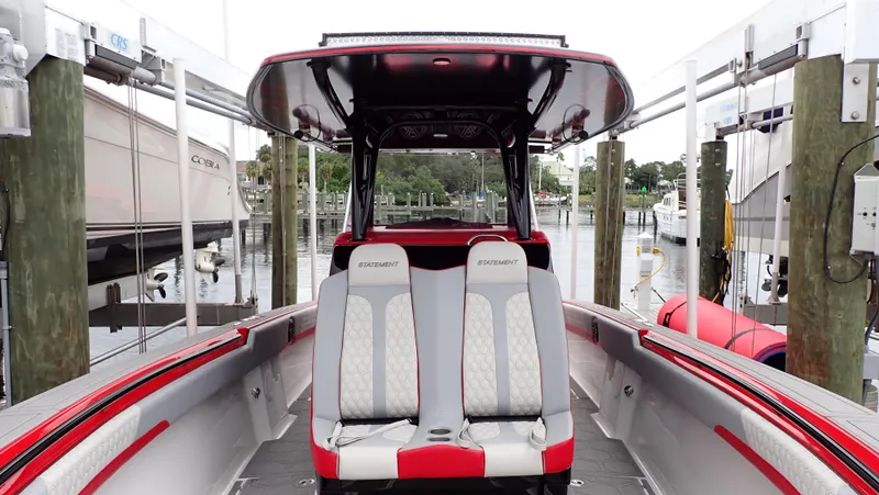Slide: The Image of 2024 Statement 350 Open boat interior with dual seats at a marina. - 15