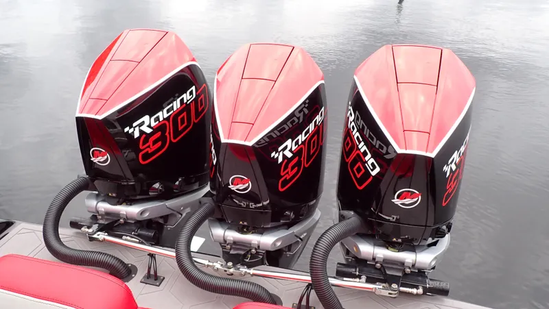 Slide: The Image of 2024 Statement 350 Open with triple Mercury Racing 300 outboard engines on water. - 2