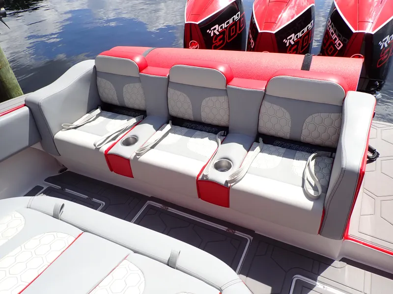 Slide: The Image of 2024 Statement 350 Open boat seating with red and gray upholstery, cup holders, and powerful engines. - 26