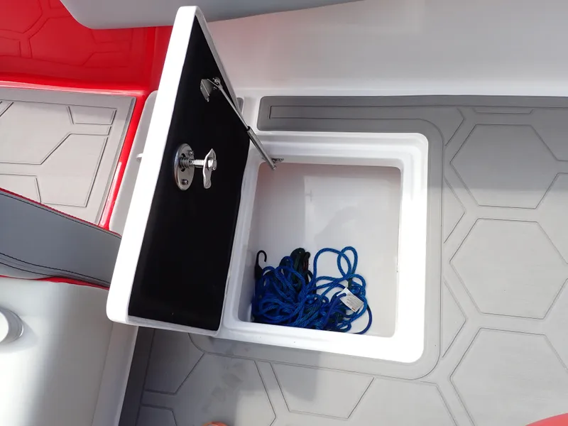 Slide: The Image of 2024 Statement 350 Open boat storage compartment with blue rope on hexagonal-patterned floor. - 36