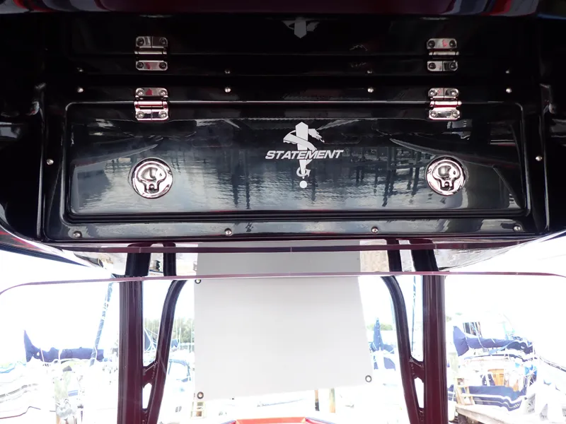 Slide: The Image of 2024 Statement 350 Open boat storage compartment with secure latches and logo. - 47