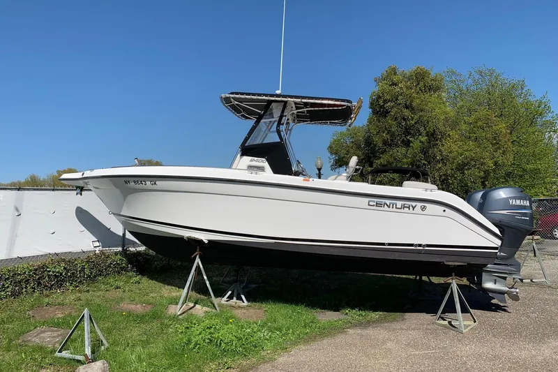 The Image of 2008 Century 2400 Center Console boat on stands, featuring Yamaha outboard motor. - 0