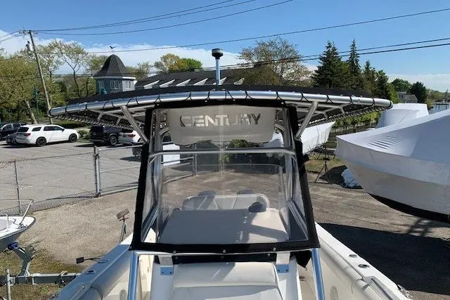 Slide: The Image of 2008 Century 2400 Center Console boat with T-top in a marina setting. - 10