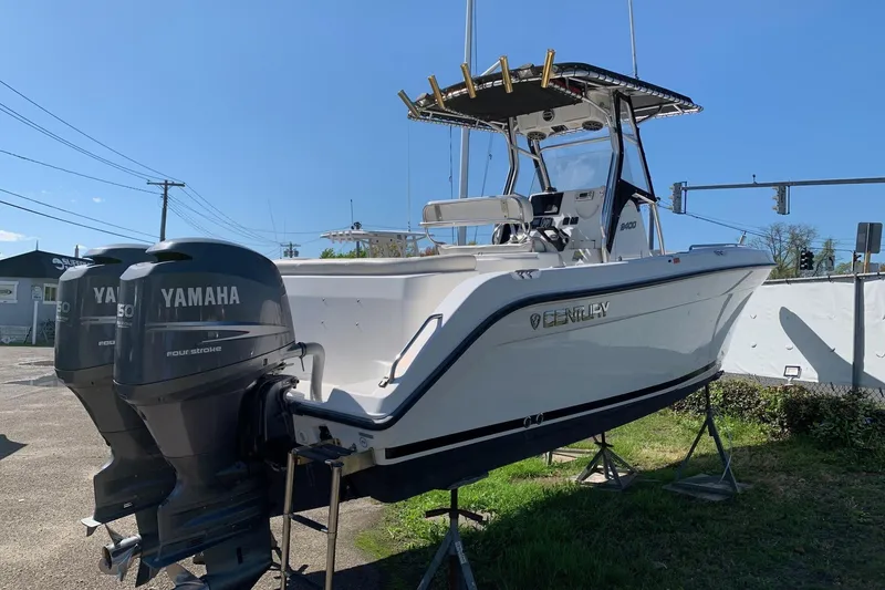 Slide: The Image of 2008 Century 2400 Center Console boat with twin Yamaha 150 engines, displayed outdoors. - 12