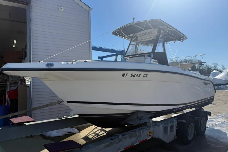 Slide: The Image of 2008 Century 2400 Center Console boat on trailer, parked outside a building. - 14