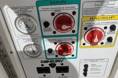 Slide: The Image of Control panel of a 2008 Century 2400 Center Console boat with volt meters and switches. - 16